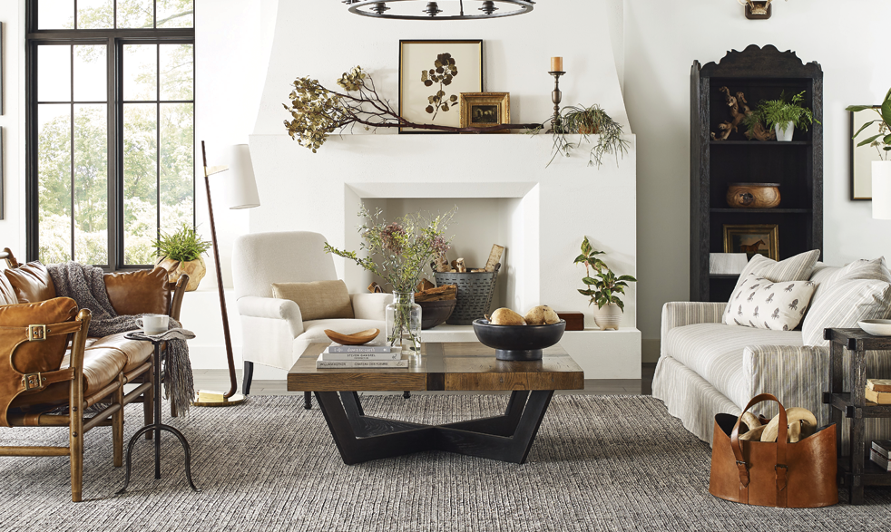 living room features a modern faux kiva fireplace as the focal point, accented with wood, leather and other neutral and organic textures